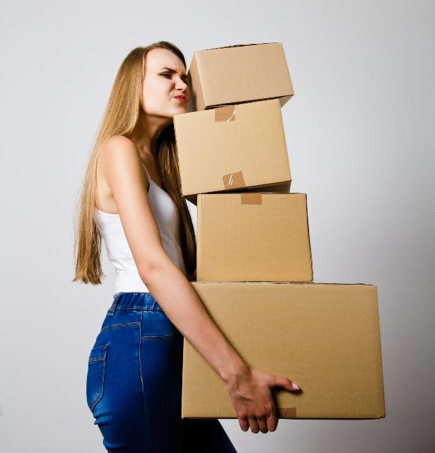 woman holding heavy boxes
